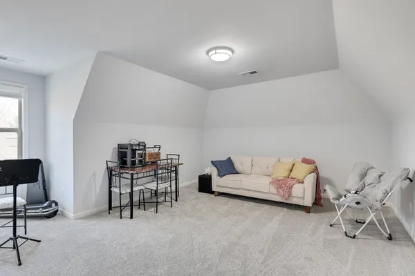 a living room with furniture and a chair