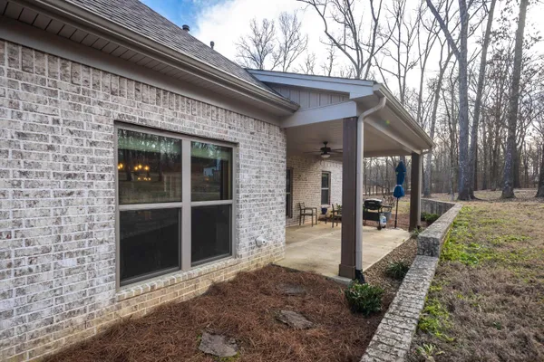 a view of a house with backyard porch and sitting area