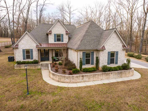 a front view of a house with a yard and porch