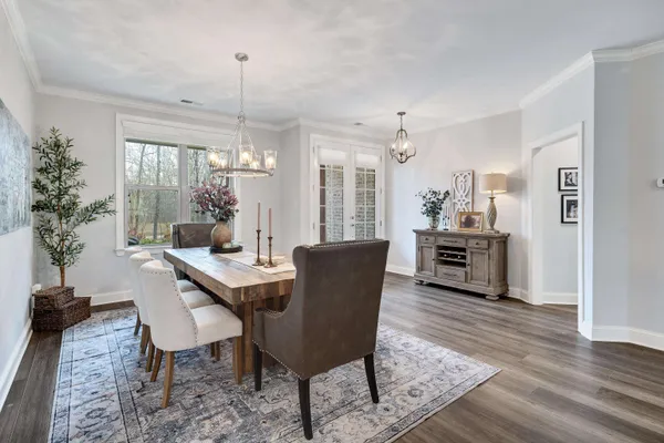 a dining room with furniture window and wooden floor