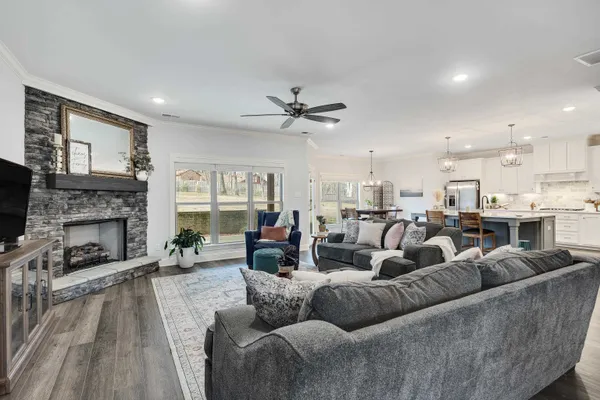 a living room with furniture kitchen view and a fireplace