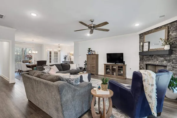 a living room with fireplace furniture and a flat screen tv