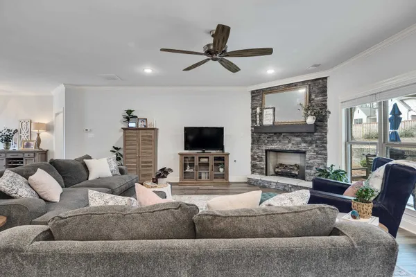 a living room with furniture and a fireplace