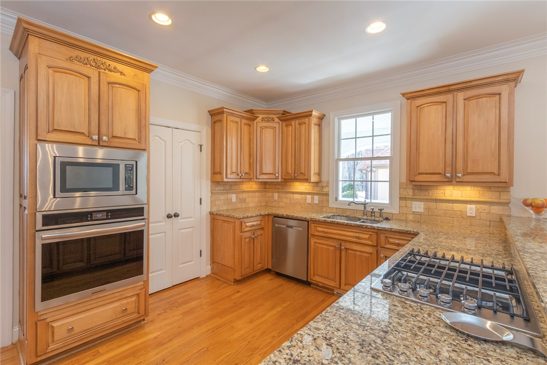 316 Avenue Of Oaks Anderson, SC 29621 - Photo 13 of 50 This spacious kitchen offers ample granite counter space and warm wooden cabinetry.