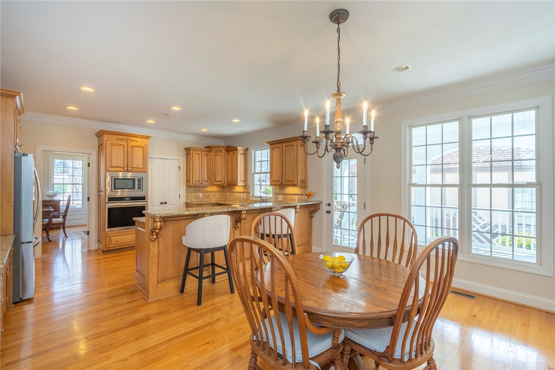 316 Avenue Of Oaks Anderson, SC 29621 - Photo 14 of 50 This bright kitchen features rich wood cabinetry and gleaming hardwood floors, creating an inviting atmosphere.