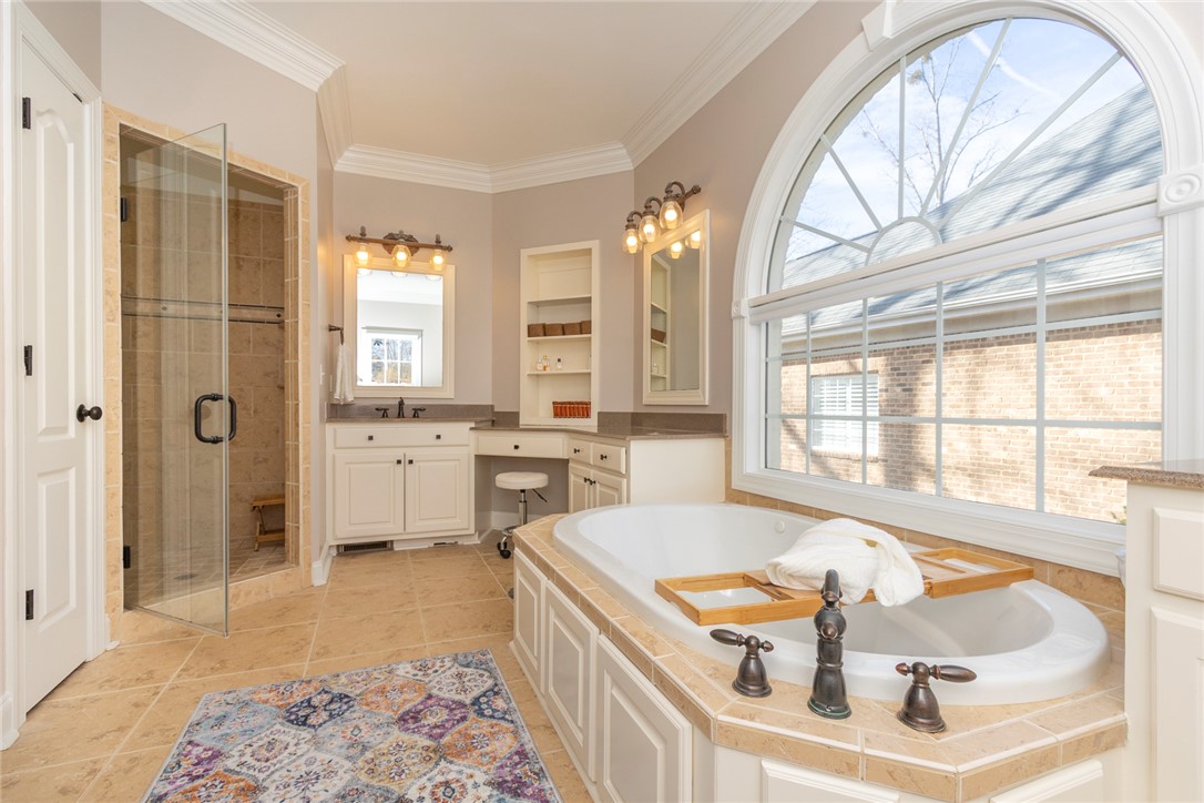316 Avenue Of Oaks Anderson, SC 29621 - Photo 24 of 50 This primary bathroom features a luxurious soaking tub, separate shower, and dual vanities.