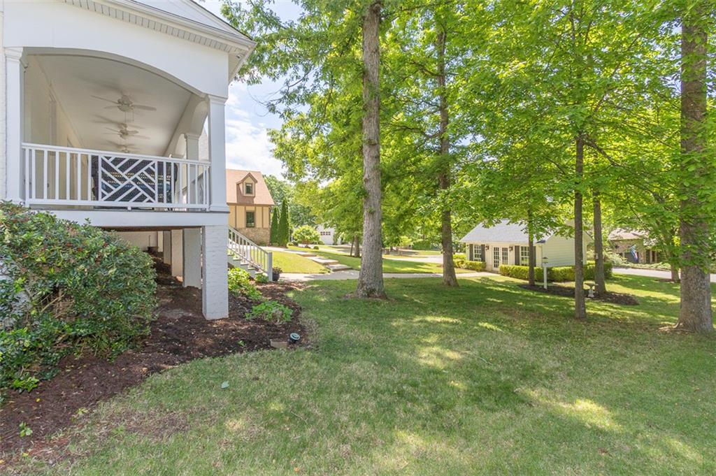 316 Avenue Of Oaks Anderson, SC 29621 - Photo 48 of 50 This spacious property offers a welcoming porch, lush lawn, and mature trees, creating a serene environment.