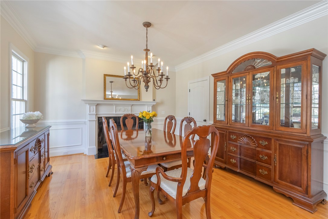 316 Avenue Of Oaks Anderson, SC 29621 - Photo 9 of 50 This elegant dining area boasts a classic fireplace and gleaming hardwood floors, perfect for gatherings.