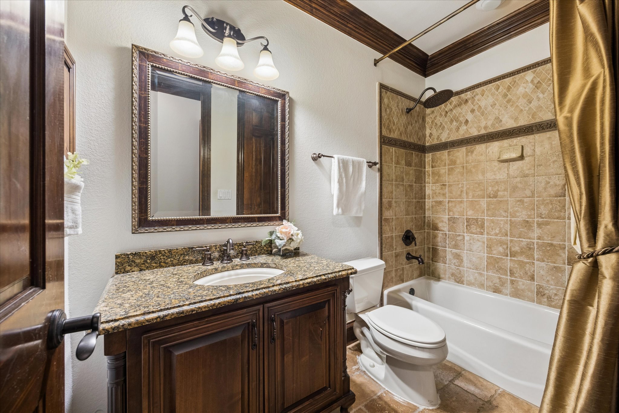 11805 Ranchview Court Austin, TX 78732 - Photo 17 of 36 Bathroom featuring a dark wood vanity with a stone countertop, an integrated sink, and an ornate framed mirror