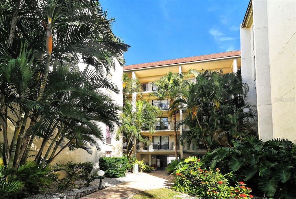 6157 Midnight Pass Road, Unit E63 Sarasota, FL 34242 - Photo 32 of 61 a view of a building from a yard