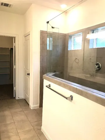 a view of a hallway with wooden floor and closet area