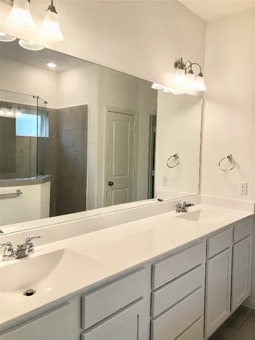 a bathroom with a shower and a sink