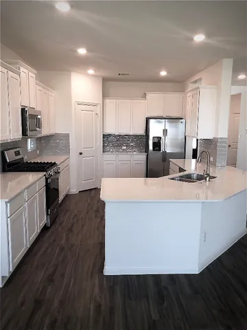 a bathroom with a glass door shower a sink and a mirror