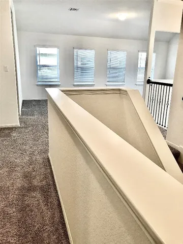 a view of hallway with windows