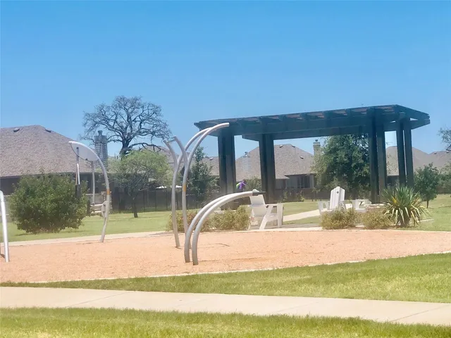 an empty room with wooden floor closet and windows