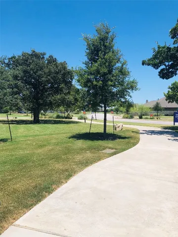 a view of a street with a building in the background