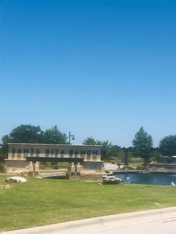 a front view of a house with swimming pool and garden