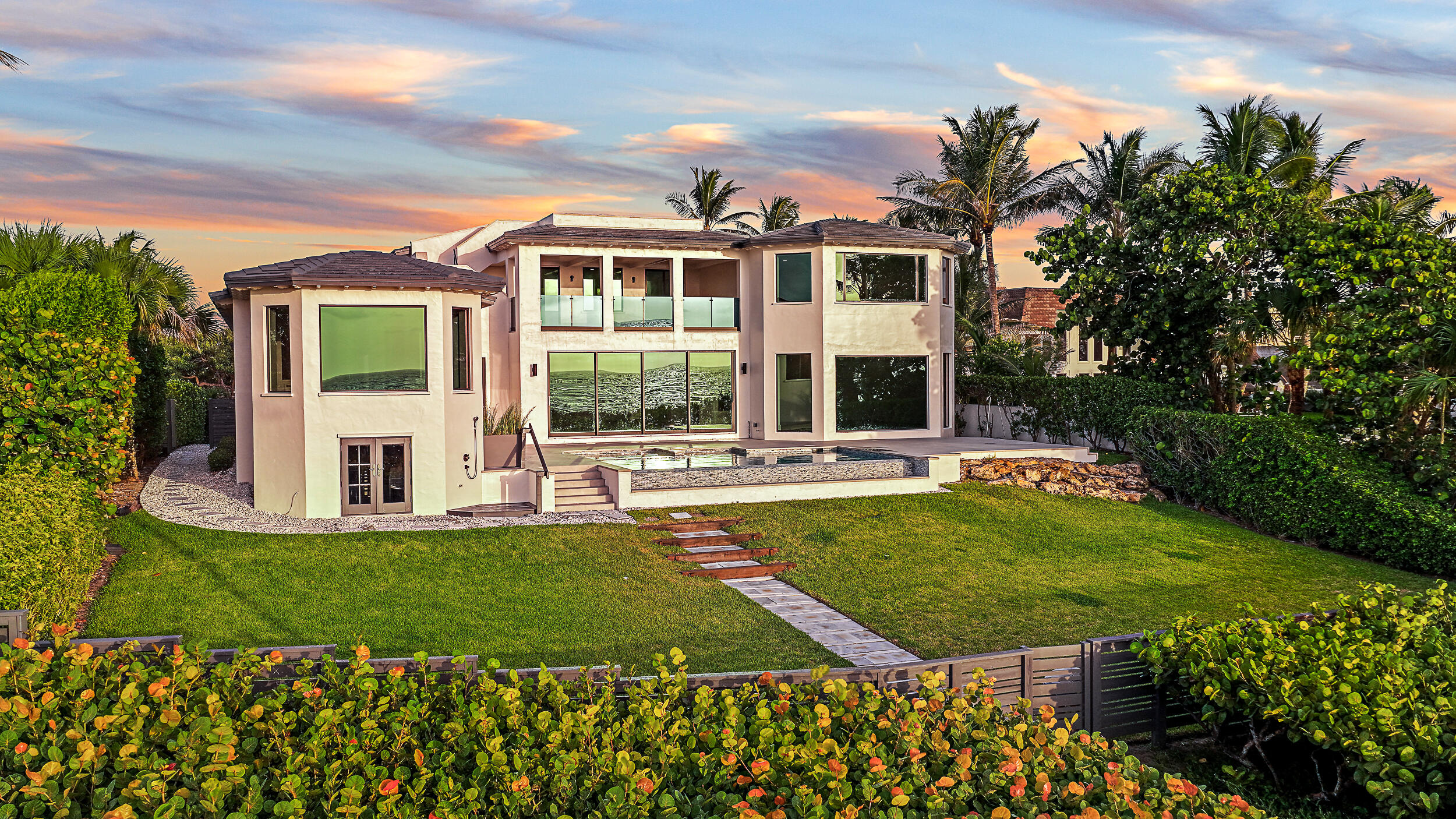 22 Ocean Drive Jupiter Inlet Colony, FL 33469 - Photo 2 of 36 a view of a house with pool and a yard