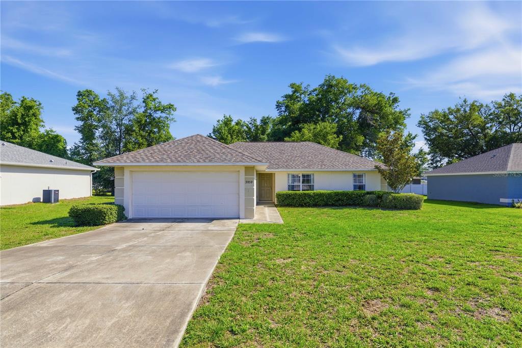 3959 Southwest 129th Street Ocala, FL 34473 - Photo 1 of 27 a front view of a house with garden