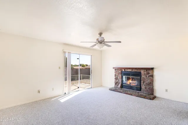 a view of livingroom and fireplace with furniture