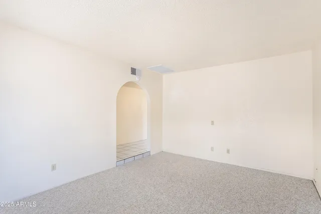 a kitchen with white cabinets a sink dishwasher and a stove with wooden floor