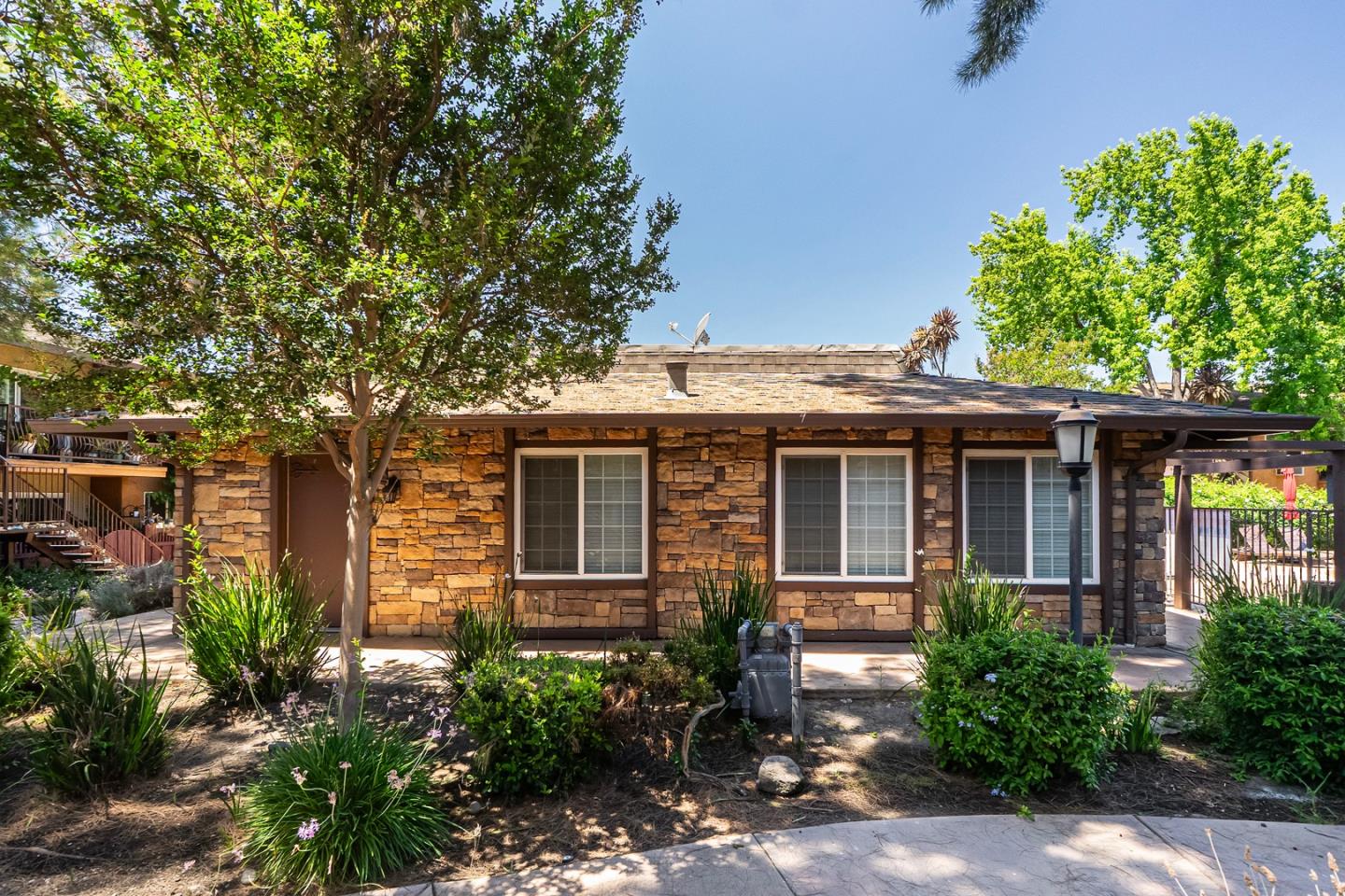 2580 Homestead Road, Unit 5201 Santa Clara, CA 95051 - Photo 27 of 38 a front view of a house with plants and trees