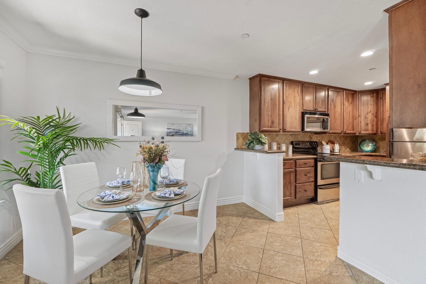 2580 Homestead Road, Unit 5201 Santa Clara, CA 95051 - Photo 7 of 38 a kitchen with kitchen island granite countertop a counter space dining table and stainless steel appliances