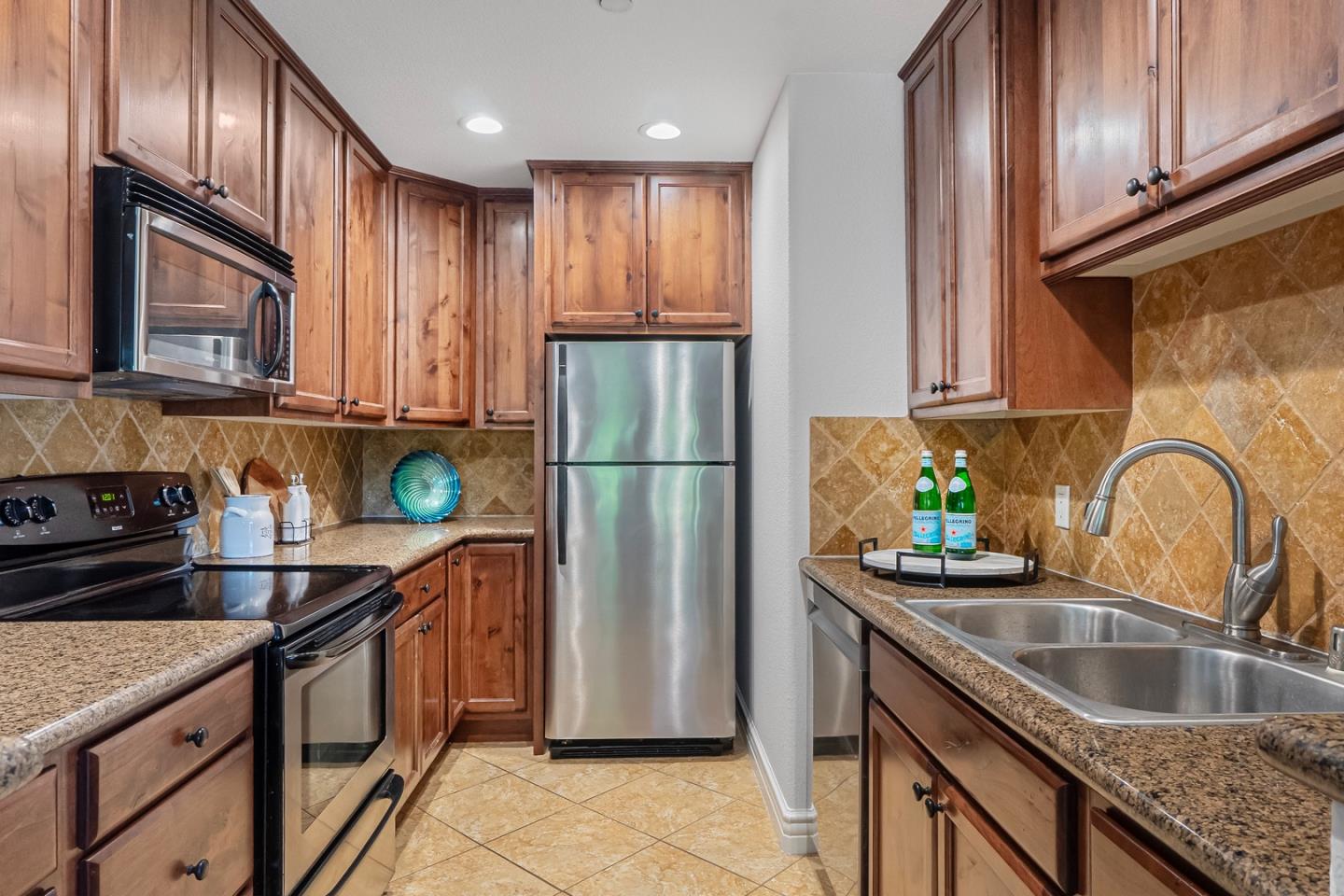 2580 Homestead Road, Unit 5201 Santa Clara, CA 95051 - Photo 9 of 38 a kitchen with stainless steel appliances granite countertop a refrigerator a sink a stove and cabinets