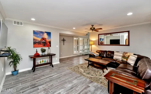a living room with furniture and wooden floor