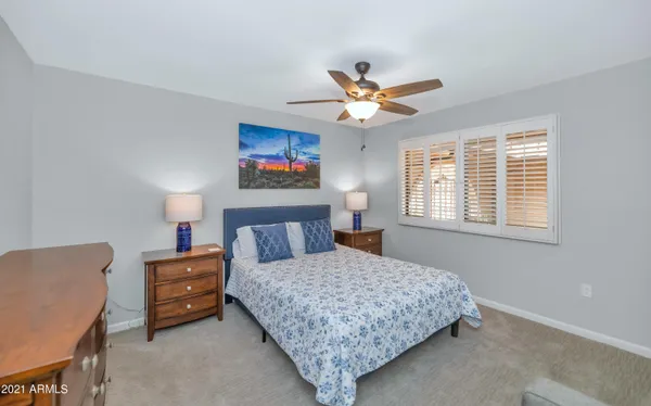 a bedroom with a bed a couch and a window