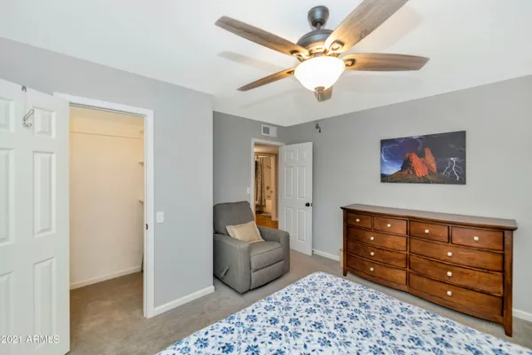 a bedroom with a bed and a chandelier