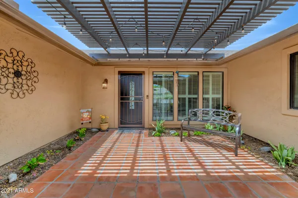 a porch with seating space and garden view