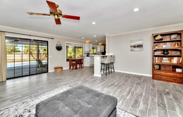 a living room with furniture and a wooden floor