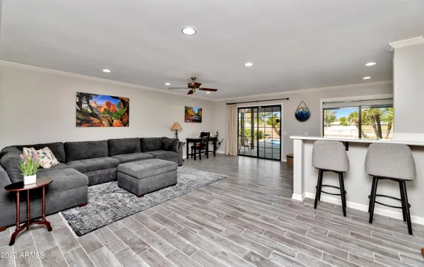 a living room with furniture a rug and a flat screen tv