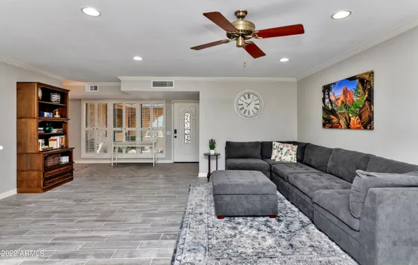 a living room with furniture and wooden floor