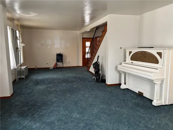 an empty room with closet and windows