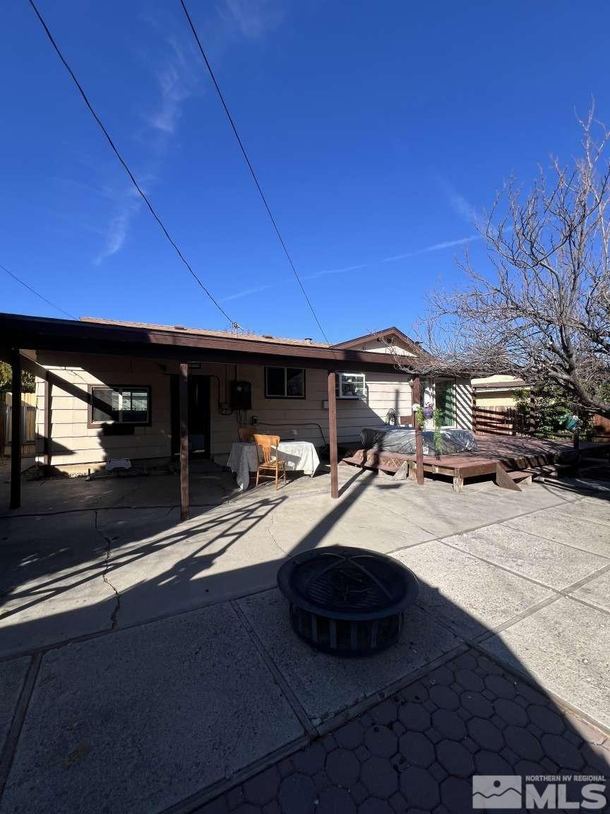 3080 Accacia Way Reno, NV 89503 - Photo 36 of 40 a view of the patio with dining table and chairs under an umbrella