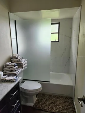 a bathroom with a toilet and a shower