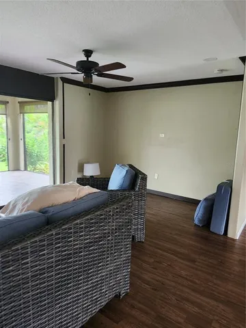 a bed sitting in a bedroom next to a window with wooden floor