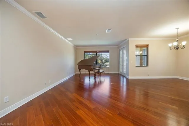 a view of a livingroom with wooden floor and furniture