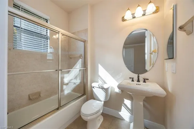 a bathroom with a toilet sink and shower