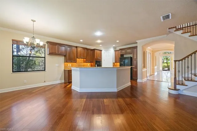 a view of a kitchen with wooden floor and a kitchen