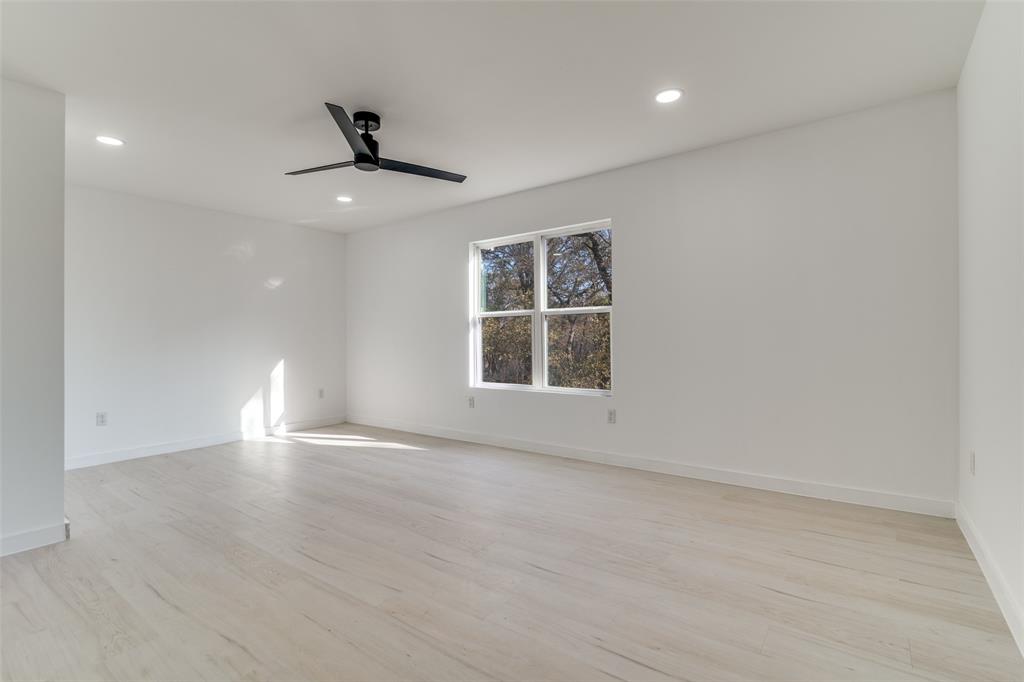 250 Skyview Point, TX 75472 - Photo 22 of 34 an empty room with ceiling fan and windows