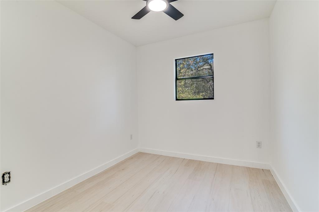 250 Skyview Point, TX 75472 - Photo 24 of 34 an empty room with a ceiling fan and window