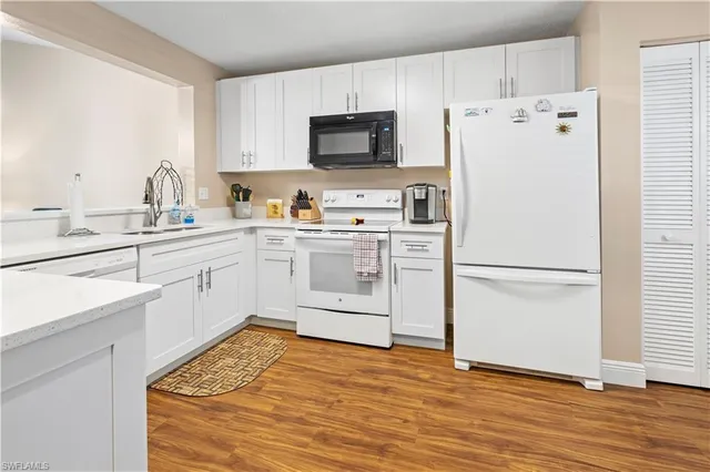 a white refrigerator freezer sitting in a kitchen