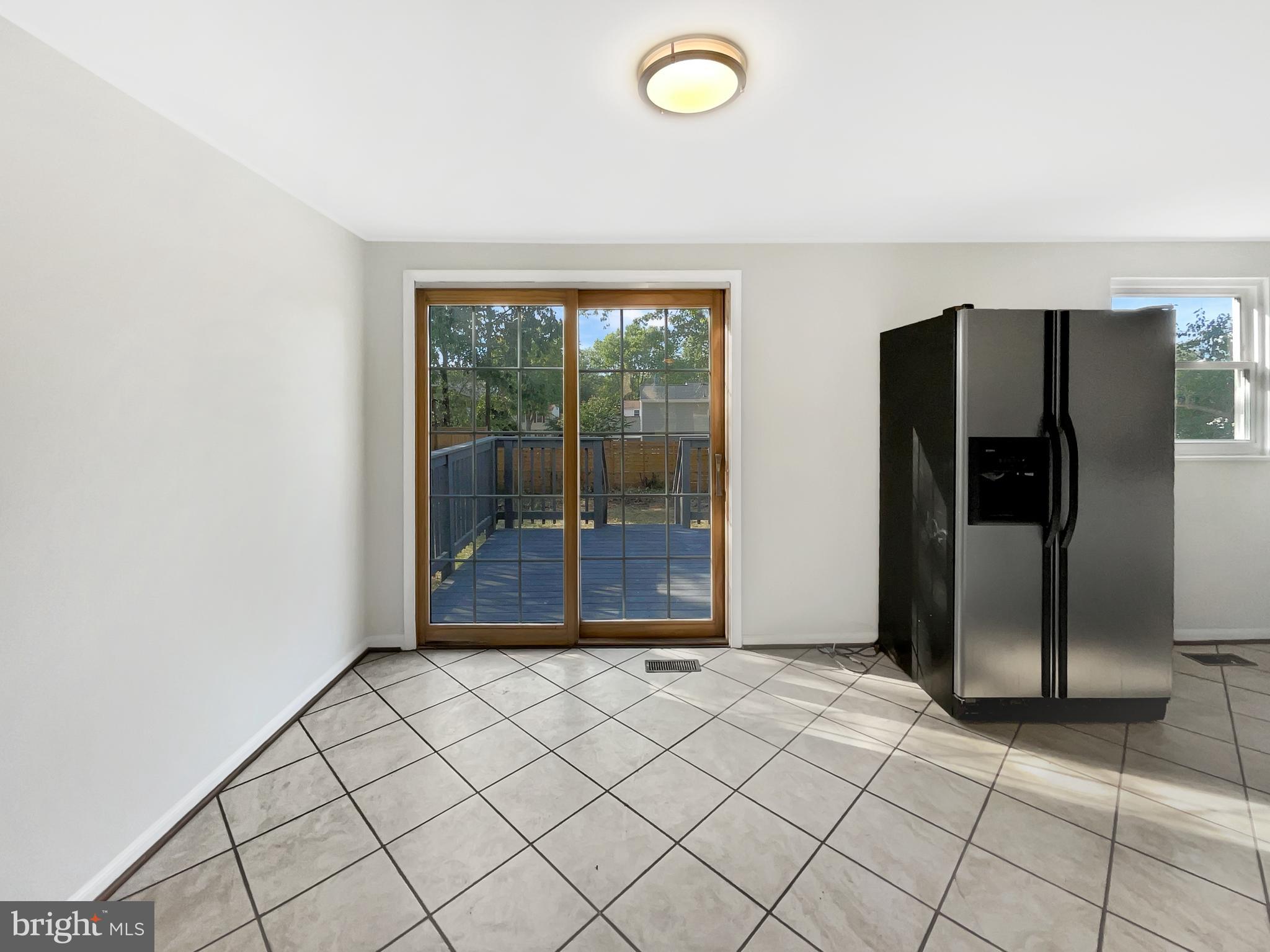 113 North Harrison Road Sterling, VA 20164 - Photo 13 of 19 an empty room with wooden floor and windows