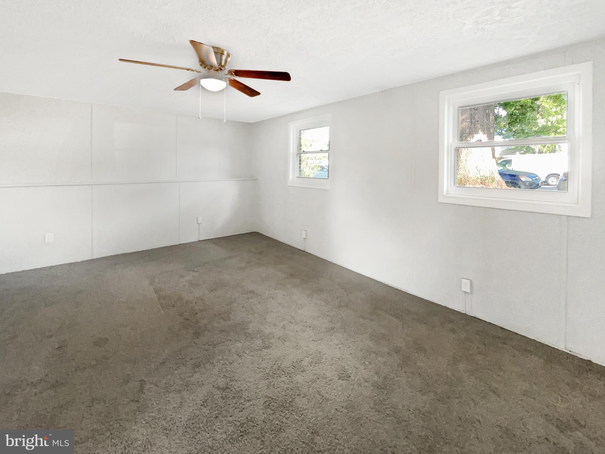 113 North Harrison Road Sterling, VA 20164 - Photo 17 of 19 an empty room with windows and ceiling fan