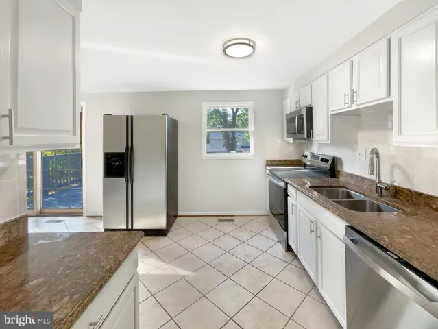 a kitchen with a sink stove and refrigerator