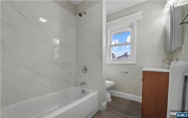 a white bath tub sitting next to a white toilet