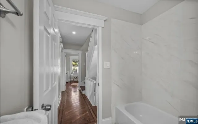 a view of a hallway view with wooden floor and staircase